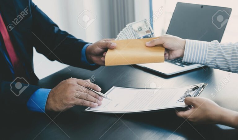 Quién es responsable de pagar las cesantías en Colombia 2 manos entregando dinero en un contrato